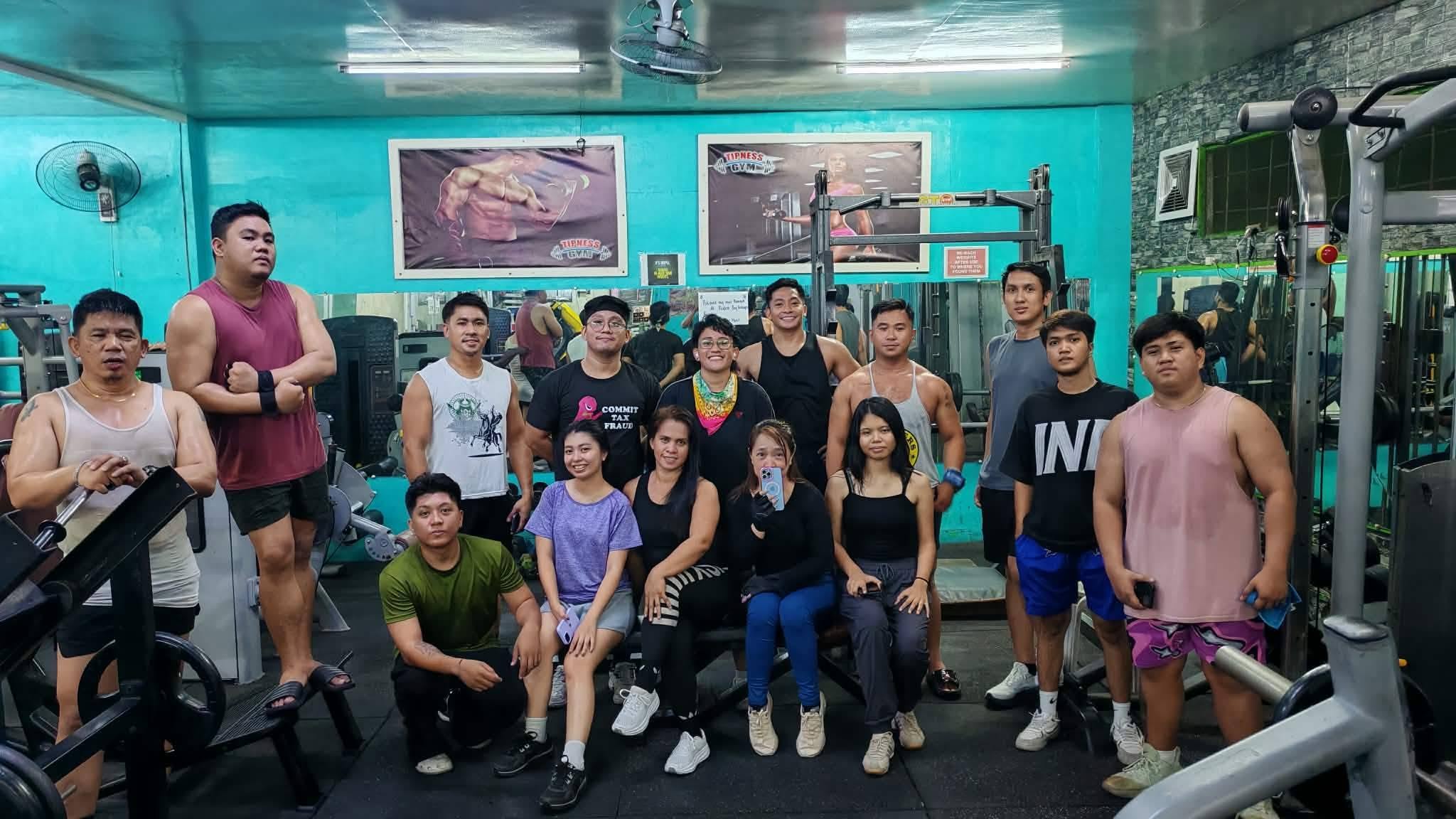 Gym regulars posing together on the training floor