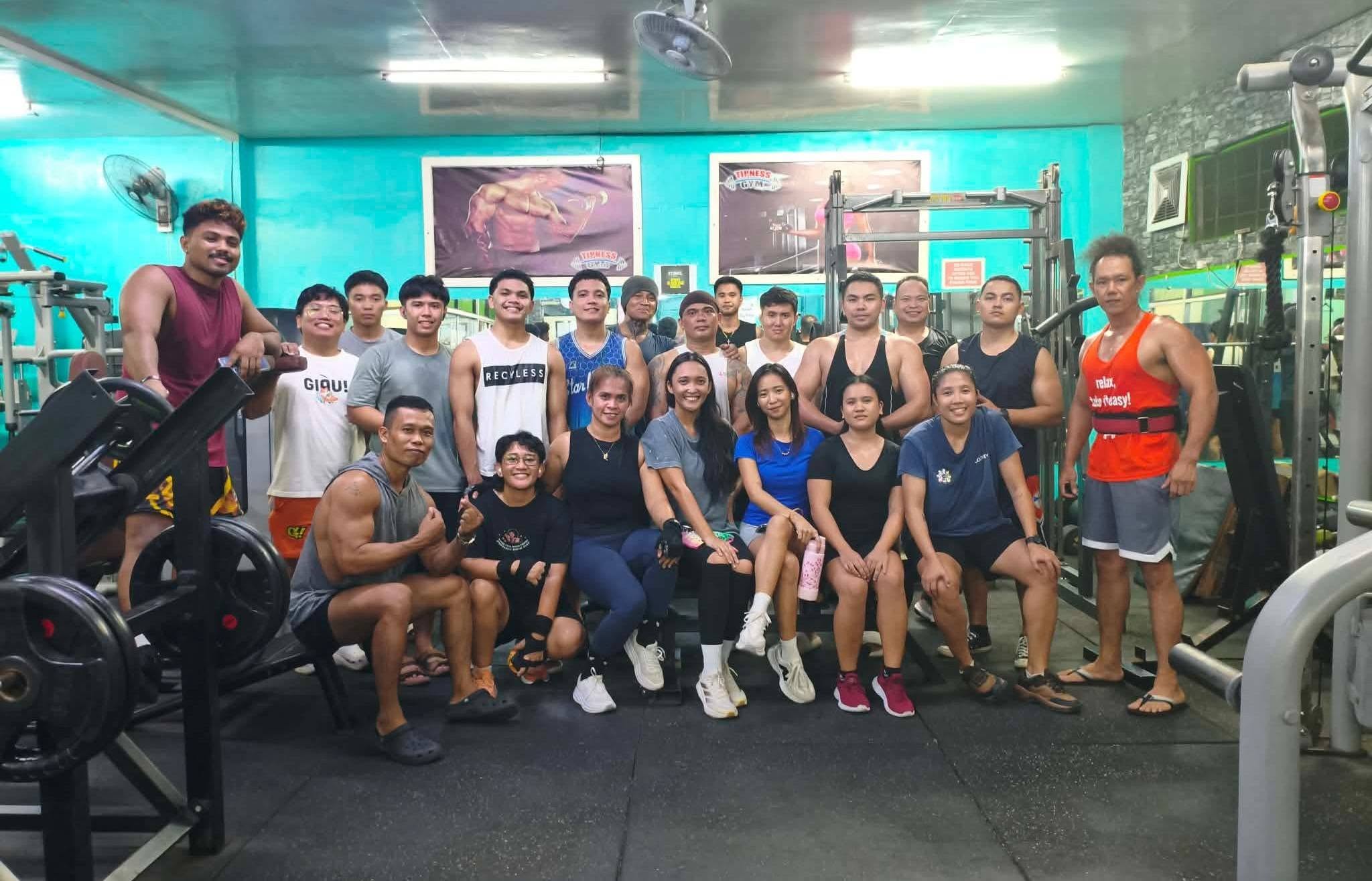 Gym members posing together after a workout